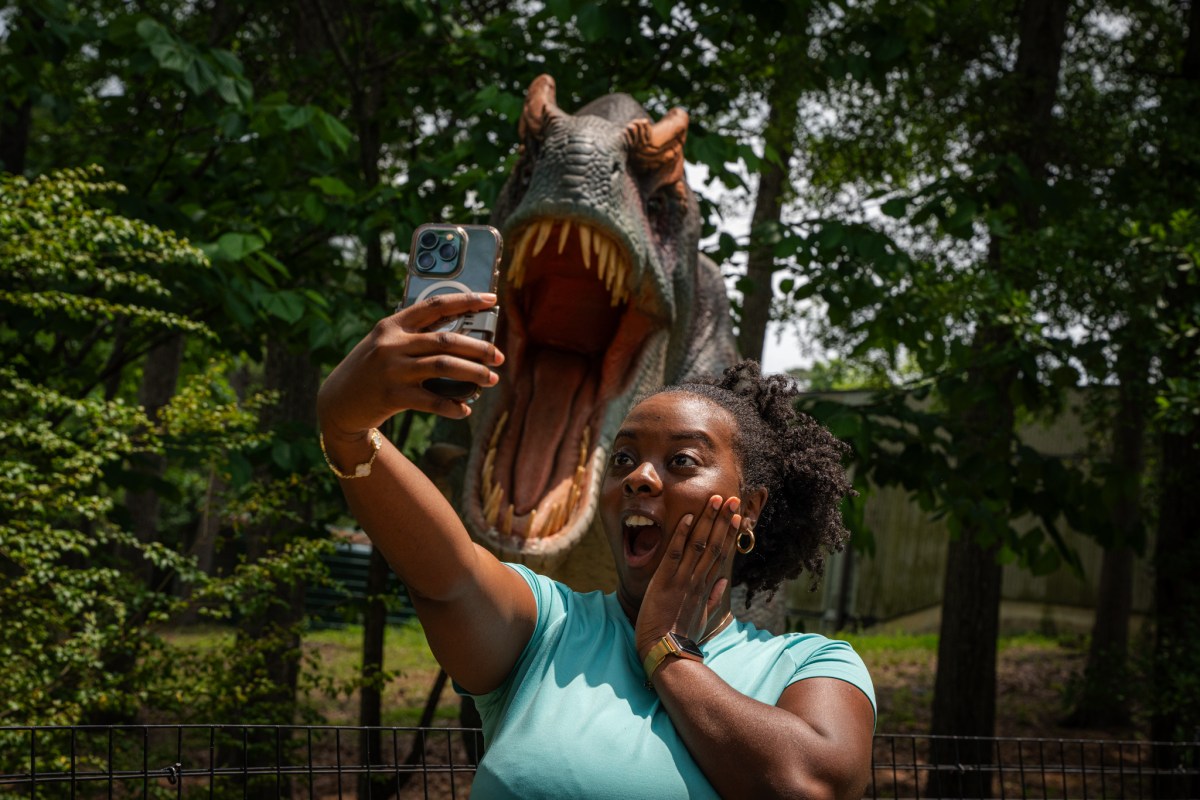 47 September Events: Birmingham Artwalk, Southbound Food Festival + more 11 woman taking a photo of herself in front of a fake roaring dinosaur