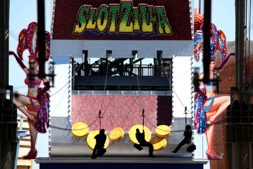 Riders fly along the zipline from Slotzilla on the second day of the attraction being open to t ...