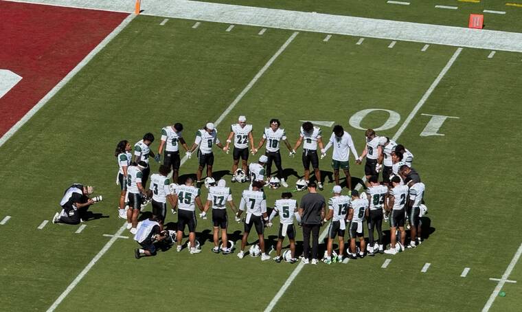 STEPHEN TSAI / STSAI@STARADVERTISER.COM
                                Members of the Hawaii football team and staff gathered pregame at Stanford Stadium in Stanford, Calif.