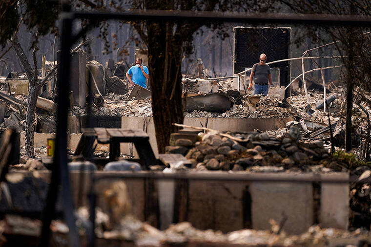 Wildfires near Spokane destroy more than 700 buildings, force 64,000 to flee
