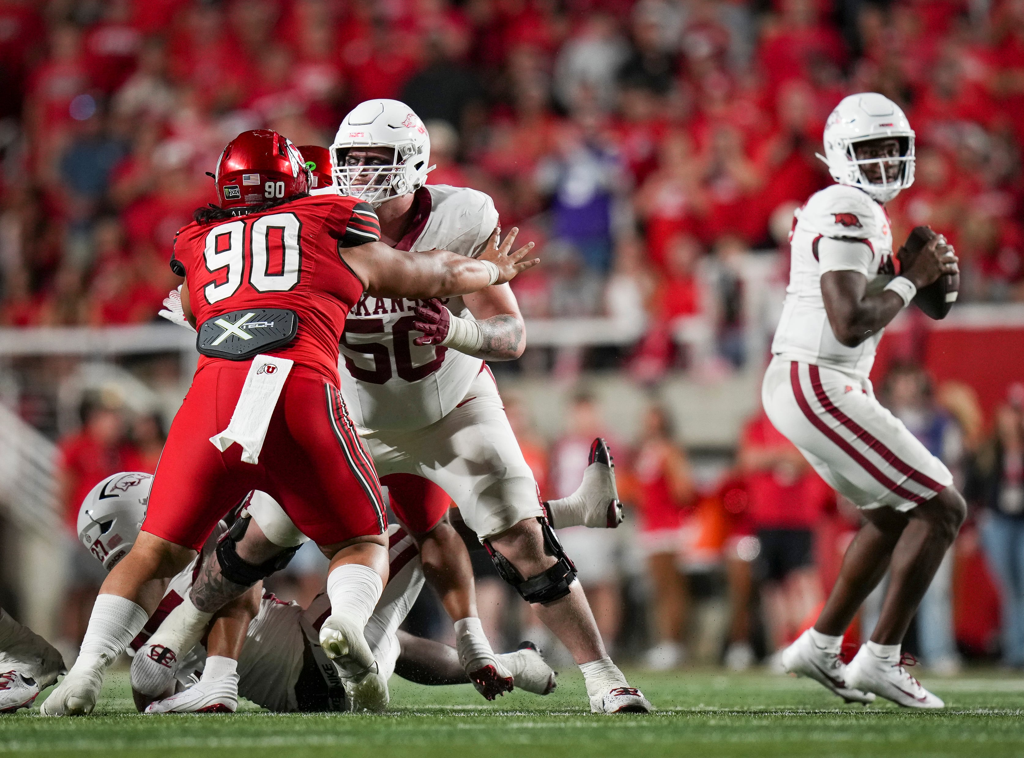 (Bethany Baker  |  The Salt Lake Tribune) Utah Utes defensive tackle Jireh Moe (90) blocks Arkansas Razorbacks offensive lineman Kobe Branham (50) during the game between the Utah Utes and the Arkansas Razorbacks in Salt Lake City on Saturday, Sept. 12, 2026.