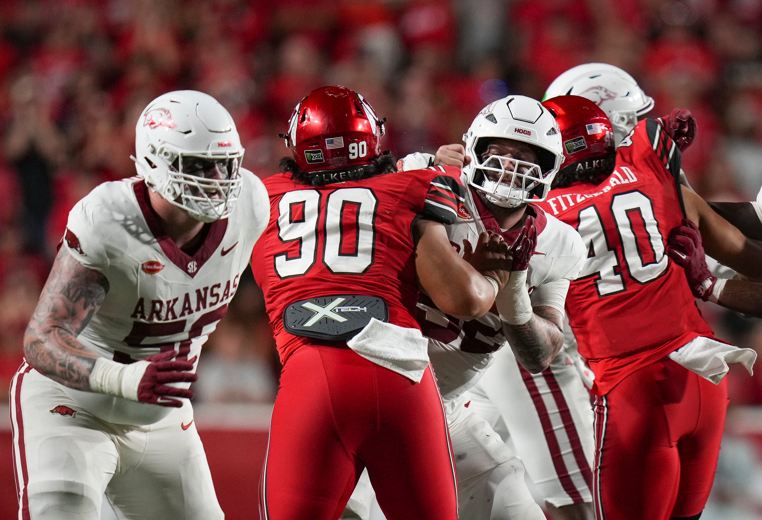 (Bethany Baker  |  The Salt Lake Tribune) Utah Utes defensive tackle Jireh Moe (90) blocks Arkansas Razorbacks defensive lineman Donovan Whitten (52) during the game between the Utah Utes and the Arkansas Razorbacks in Salt Lake City on Saturday, Sept. 12, 2026.