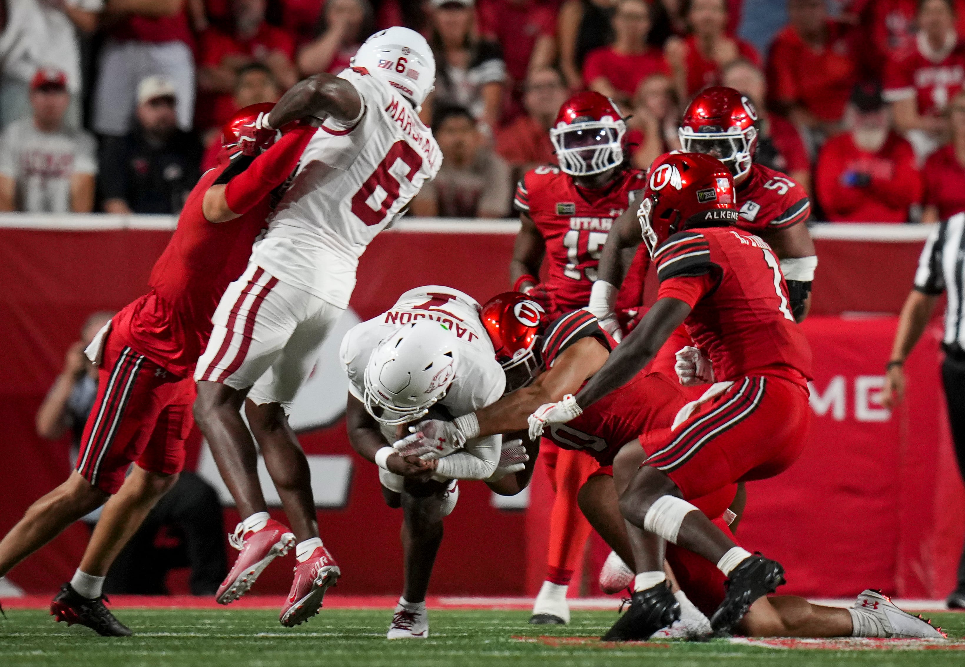(Bethany Baker  |  The Salt Lake Tribune) Utah Utes linebacker Cyrus Polu (0) tackles Arkansas Razorbacks quarterback KJ Jackson (7) during the game between the Utah Utes and the Arkansas Razorbacks in Salt Lake City on Saturday, Sept. 12, 2026.