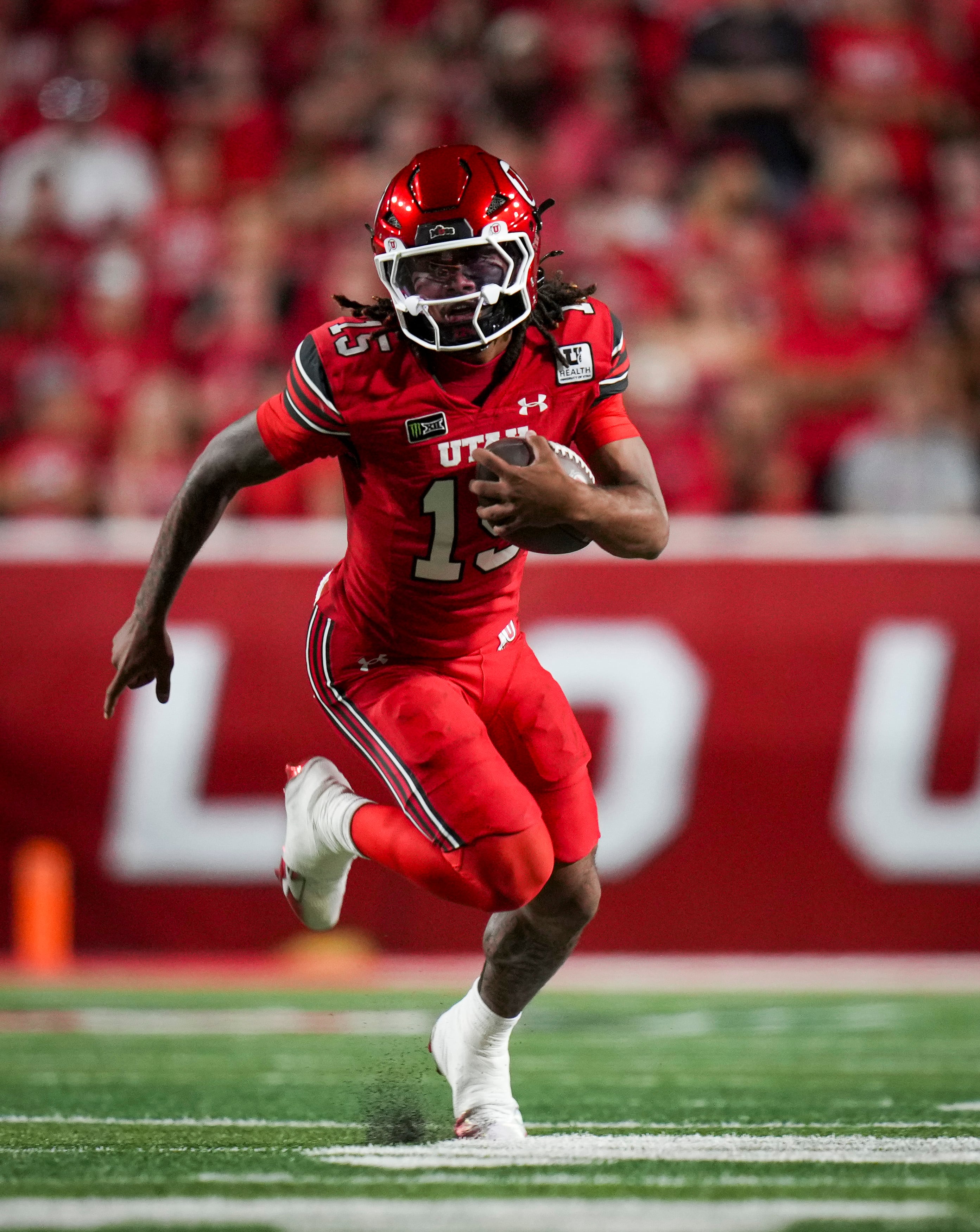(Bethany Baker  |  The Salt Lake Tribune) Utah Utes quarterback Byrd Ficklin (15) runs the ball during the game between the Utah Utes and the Arkansas Razorbacks in Salt Lake City on Saturday, Sept. 12, 2026.