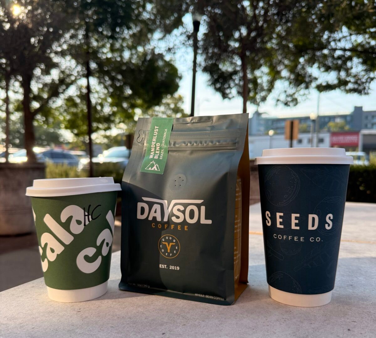 BHAM Coffee Fest: Local vendors, free samples + a good cause at Pepper Place, Sept. 26 2 2 to-go coffee cups and 1 bag of coffee beans sitting on a table outside