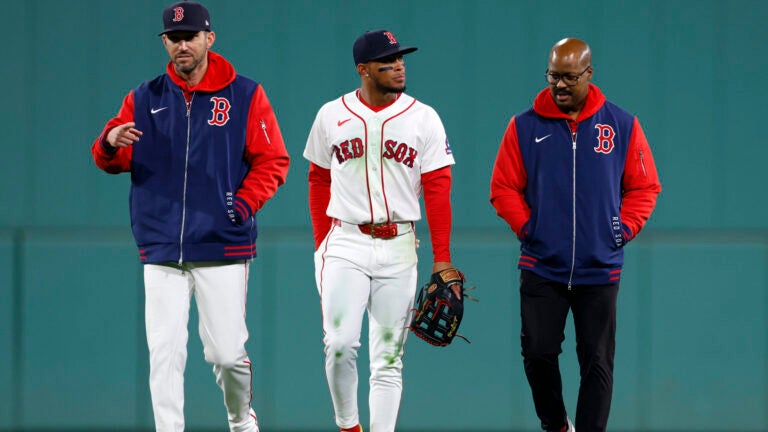 Boston Red Sox manager Chad Tracy, left, walks center fielder Ceddanne Rafaela (3) off the field during the third inning at Fenway Park on Sept. 23, 2026, in Boston.