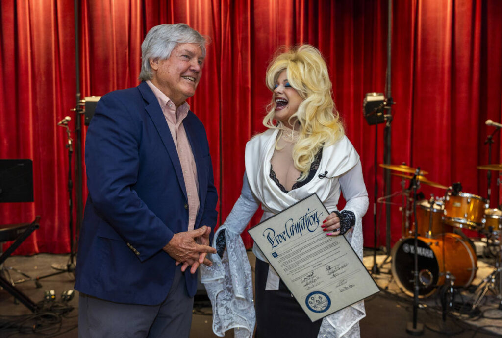 Dolly Parton impressionist Kelly Vohnn sings after presented with a proclamation from County Co ...