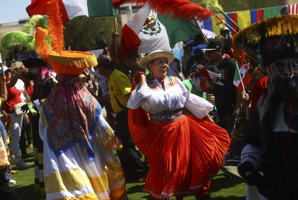 Attendees dance during the fifth annual kickoff celebration for Hispanic Heritage Month on Sund ...