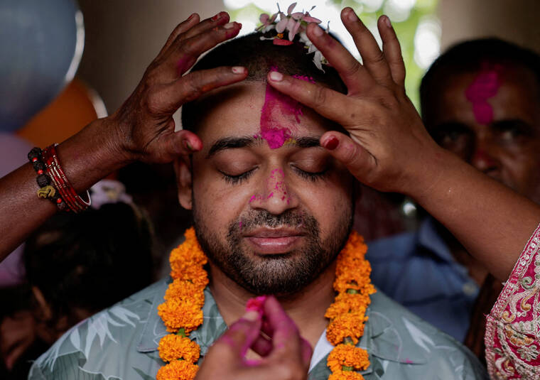 REUTERS/NAVESH CHITRAKAR
                                Family members offers tika to Sanjay Sah, a survivor pulled out alive after spending nine days trapped in a hydropower station tunnel following flash floods and a mudslide, upon his arrival at his house for the first time after being rescued from the tunnel, in Tilathi Koiladi village in Saptari District, Nepal.