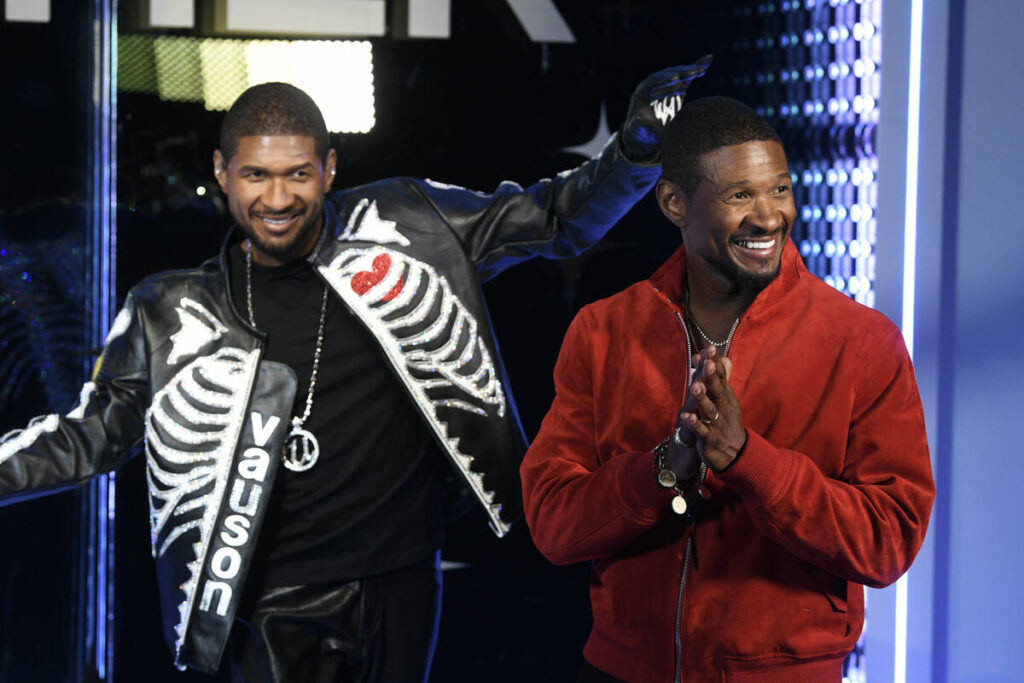 Artist Usher interacts with a wax figure made in his likeness at Madame Tussaud’s in Las ...