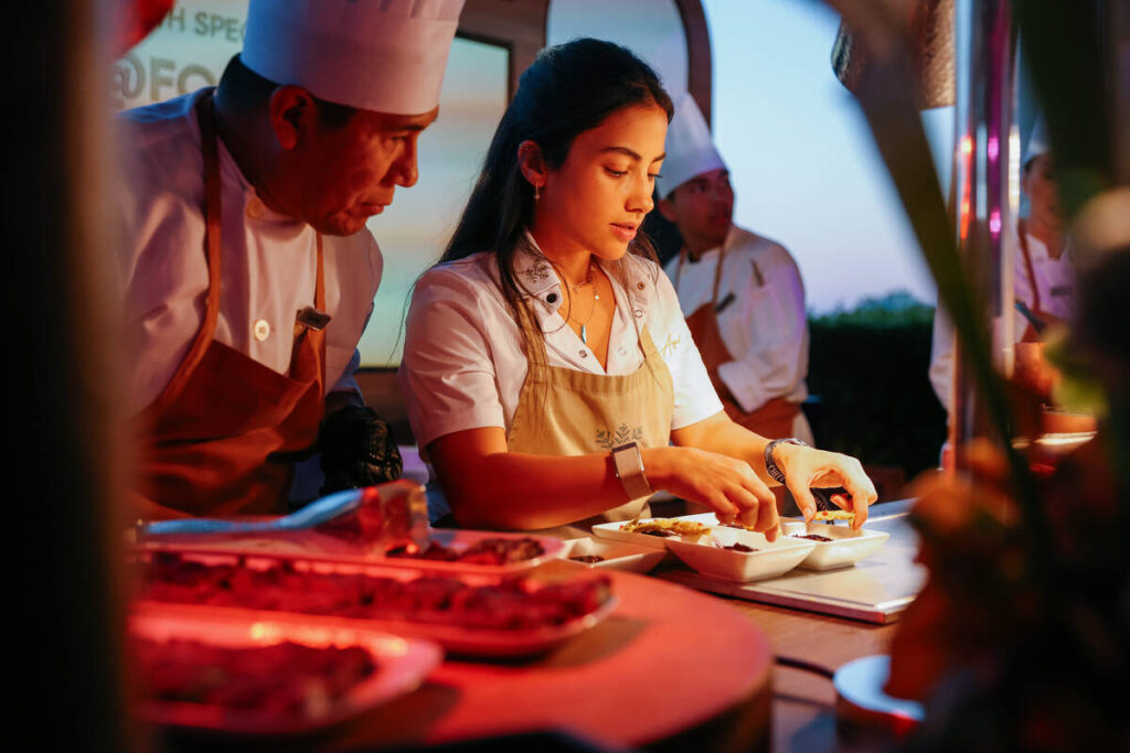Chef Sara Aqel arranges her braised short rib dishes at her booth during The Feast, part of Rev ...