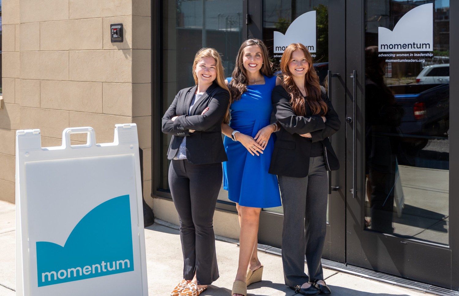 three businesswomen stand in front of Momentum Leaders HQ in Birmingham, AL