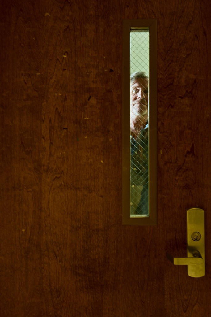 Author Adam O'Fallon Price poses for a portrait in the stairwell of his office building at UNC-Chapel Hill. Photo by Matt Ramey.