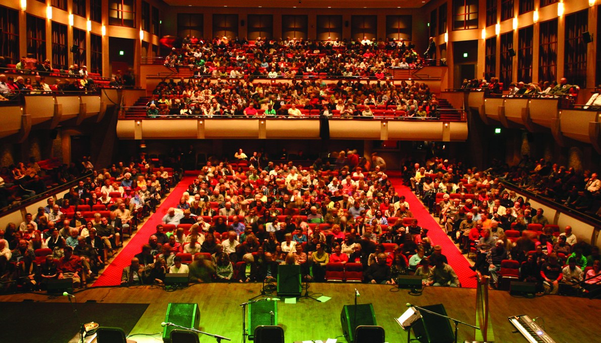 Crowded auditorium before a performance.
