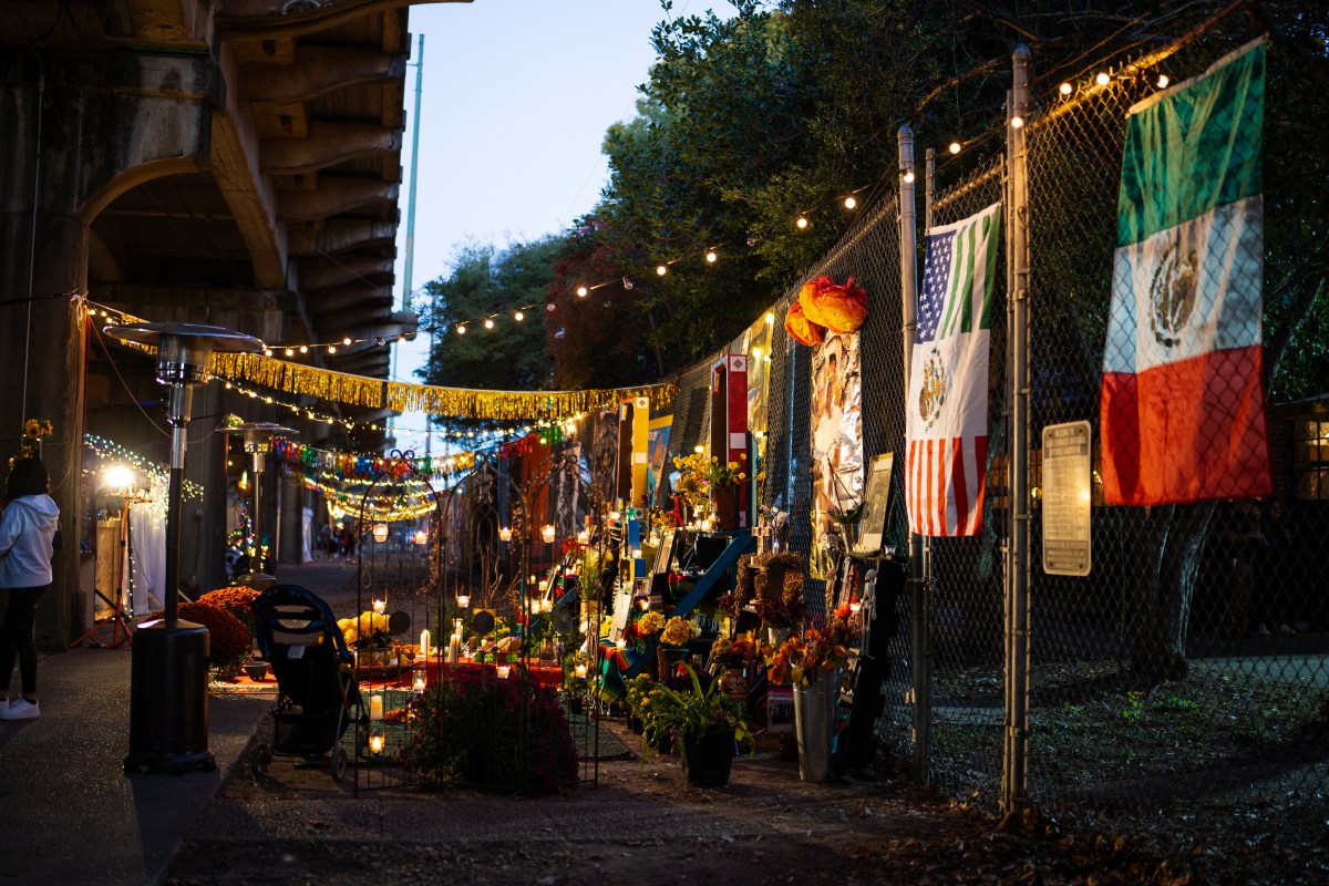 6 ways to celebrate Día de los Muertos in Birmingham 4 Ofrendas with candles, flowers and photos line a fence strung with lights for Día de los Muertos at Sloss Furnaces